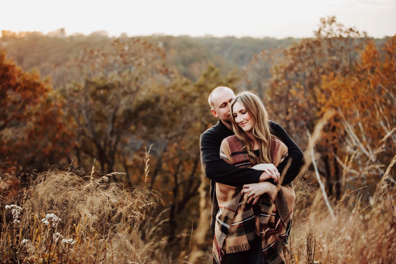 Wedding and Elopement Photography, man wrapping his arms and a blanket around woman