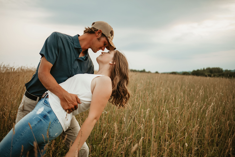 Wedding and Elopement Photography, man dipping woman for a kiss in a wide field